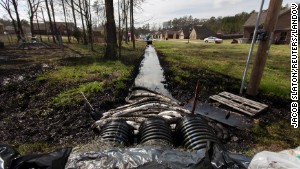 Canadian crude from an Exxon Mobile pipeline fills a ditch near evacuated homes in Mayflower, Arkansas, in 2012. 