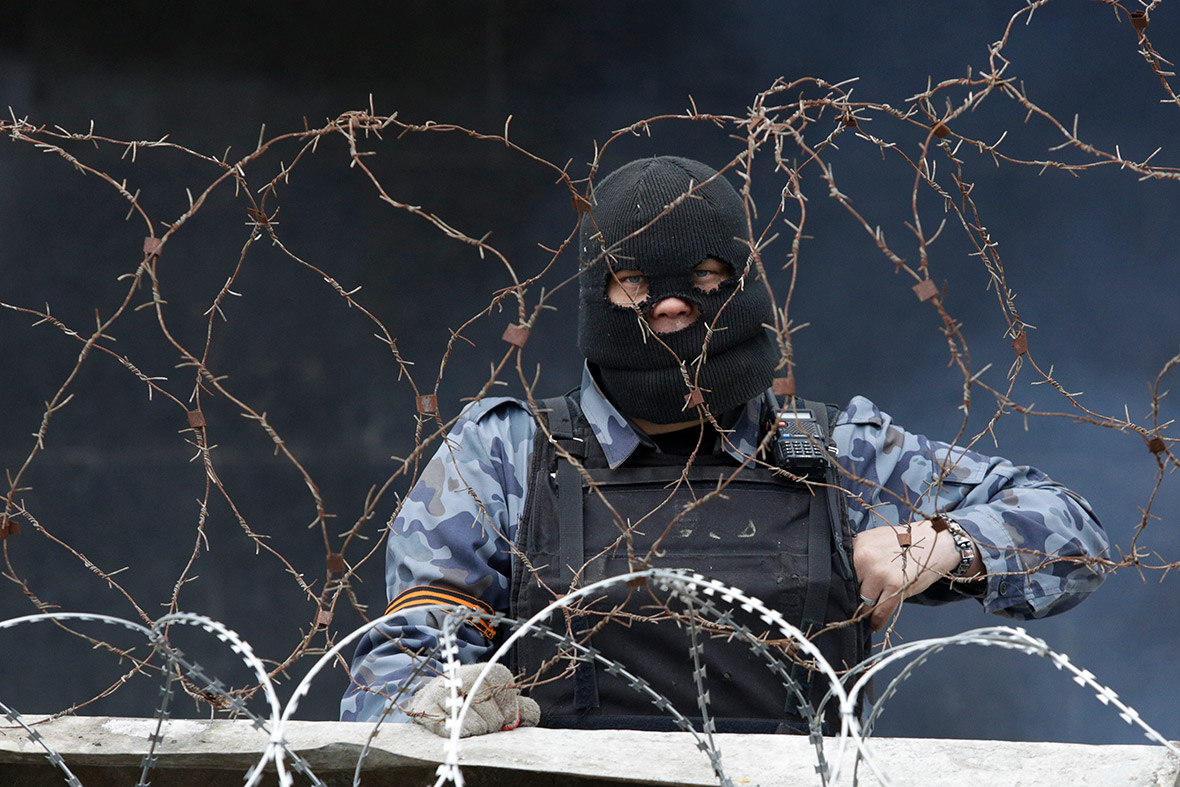 A pro-Russia protester stands at a barricade outside a regional government building in Donetsk, eastern Ukraine