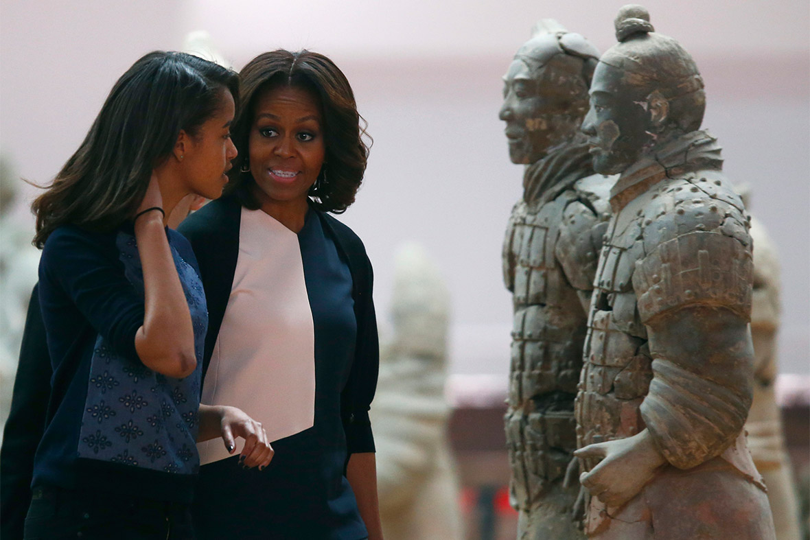 US first lady Michelle Obama talks to her daughter Malia as they visit the Museum of Qin Terracotta Warriors and Horses, in Xi'an, Shaanxi province, China