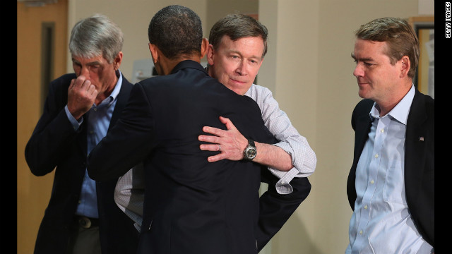 President Barack Obama embraces Colorado Gov. John Hickenlooper as Sen. Mark Udall, left, and Sen. Michael Bennet look on during a visit to the University of Colorado Hospital on Sunday.