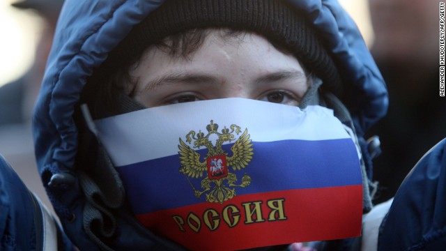 A young demonstrator with his mouth covered by a Russian flag attends a pro-Russia rally outside the regional government administration building in Donetsk on Saturday, April 5. 
