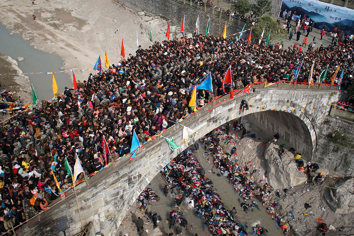 People crowd onto a bridge during the annual Caiqiaohui event in Mianyang, Sichuan province, China. People believe that stepping onto the bridge during the three-day spring event can help cure them of their worries and illnesses