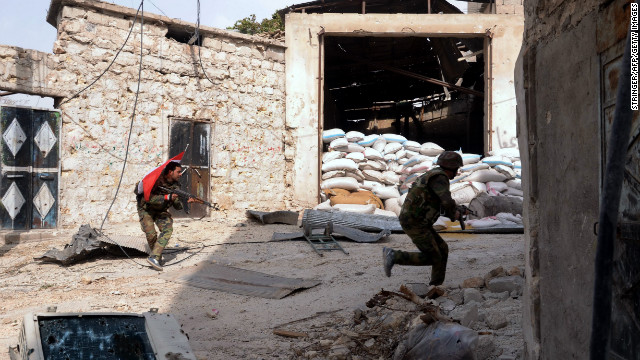 Syrian army soldiers run for cover during clashes with rebel fighters at Karam al-Jabal neighborhood of Aleppo on October 20, 2012.