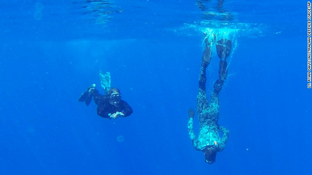 Australian Defense Force divers from the Ocean Shield vessel scan the water for debris in the southern Indian Ocean on Monday, April 7.