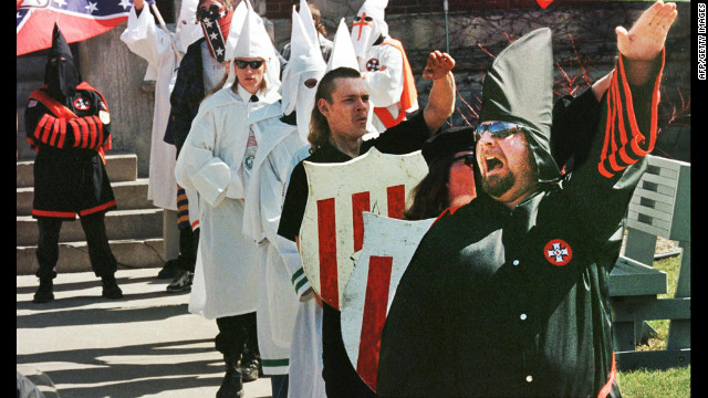 Ku Klux Klan members chant "white power" during a rally to recruit members on the steps of the Defiance, Ohio, courthouse in 1999.