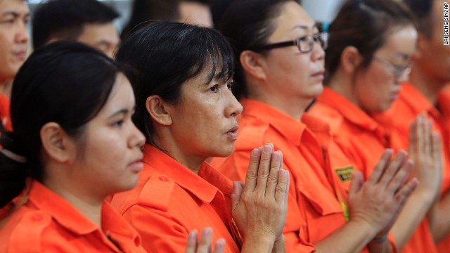 Members of Fo Guang Shan rescue team offer a special prayer on Sunday, March 9, at Kuala Lumpur International Airport in Sepang, Malaysia, for passengers aboard a missing Malaysia Airlines flight. C