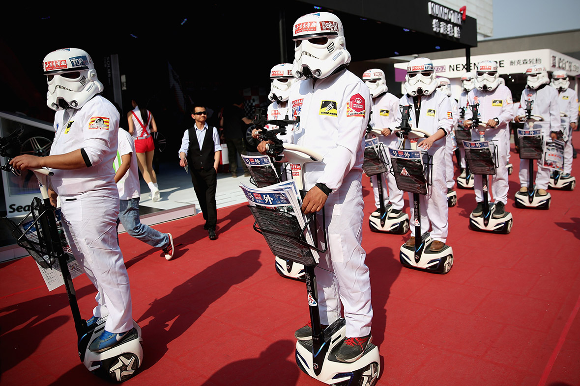 People dressed as Star Wars stormtroopers distribute promotional material to visitors during the 2014 Beijing International Automotive Exhibition