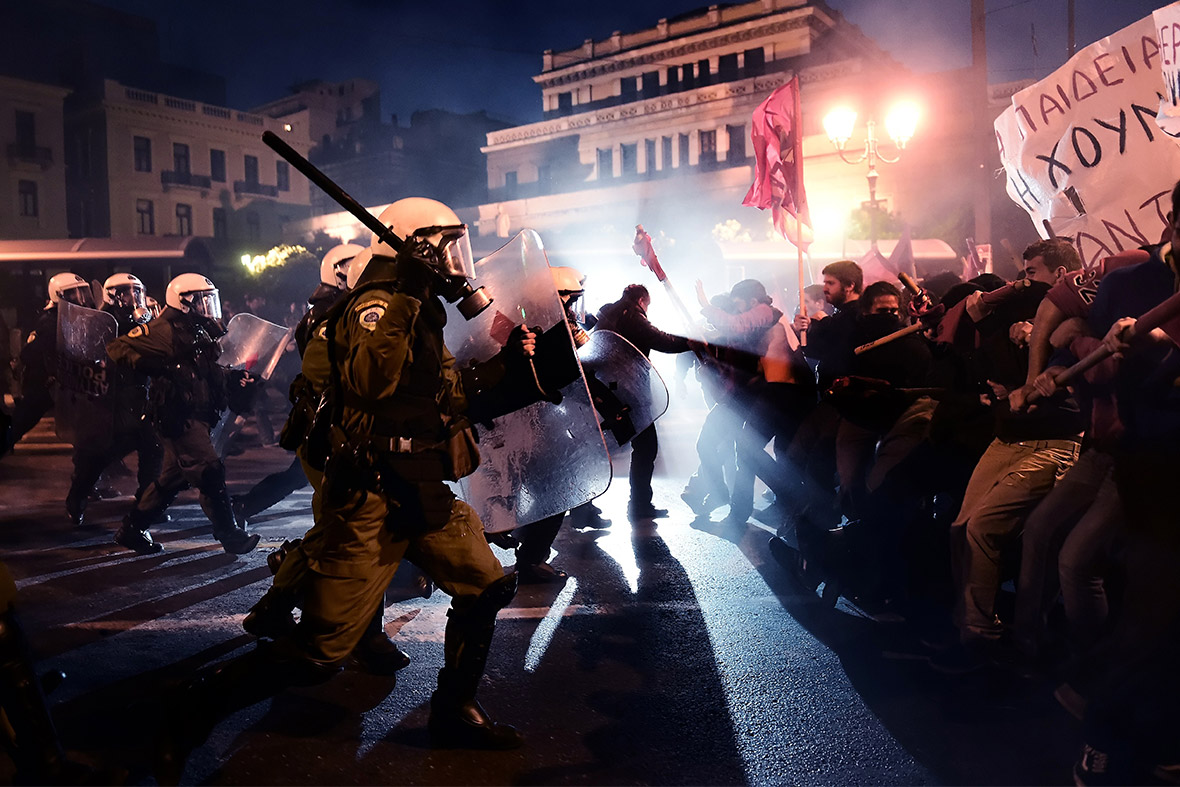 Riot police and demonstrators clash during a bailout protest in Athens