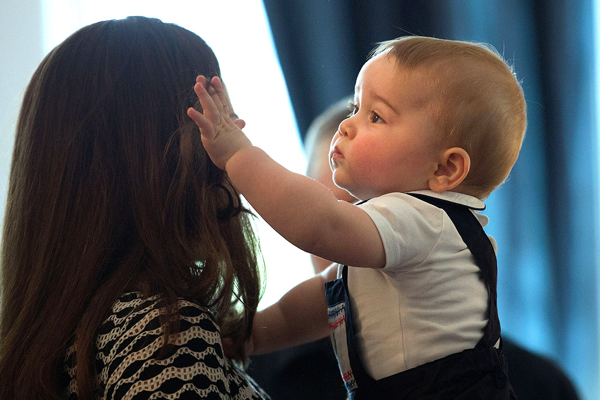 Prince George plays with his mother's hair on his first official engagement during their royal tour of New Zealand