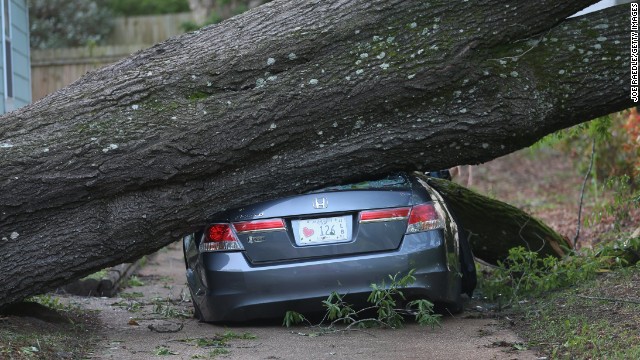 A large tree left a car smashed in Tupelo, Mississippi, on April 30.