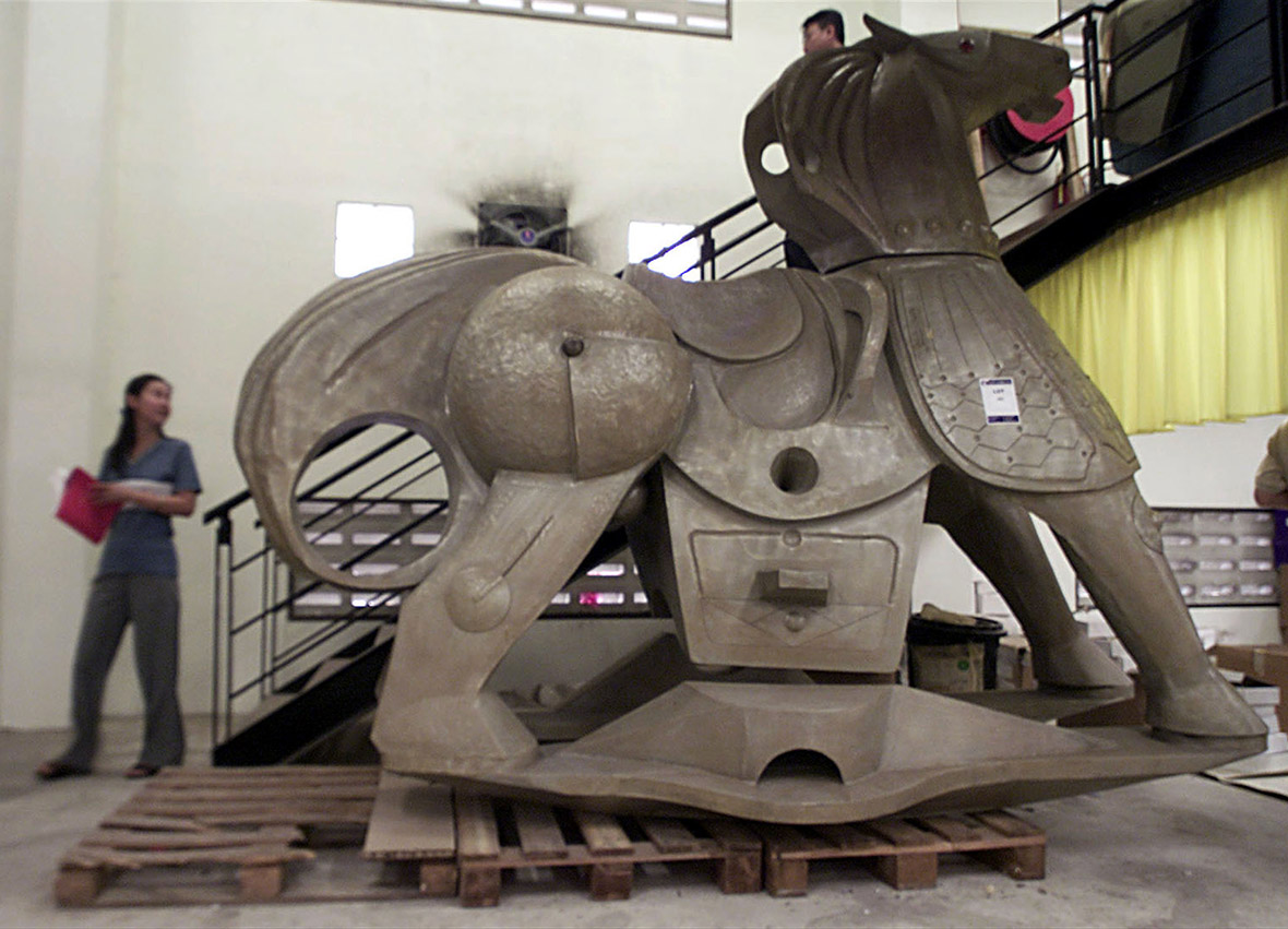 August 11, 2001: A woman walks past a giant rocking horse at a multi-million dollar auction of 10,000 items that once belonged to Prince Jefri, the Sultan's estranged younger brother