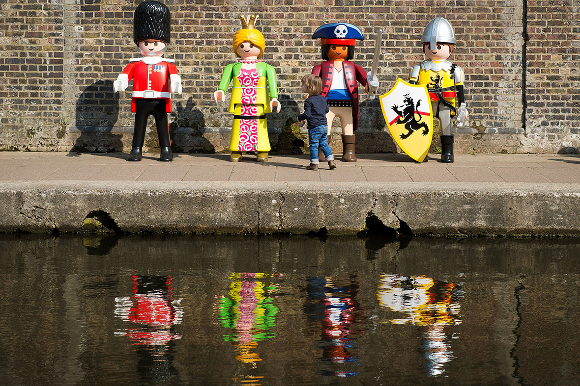 A child plays with giant Playmobil figures set up along the canal in Camden, north London, as the toy company celebrates its 40th anniversary