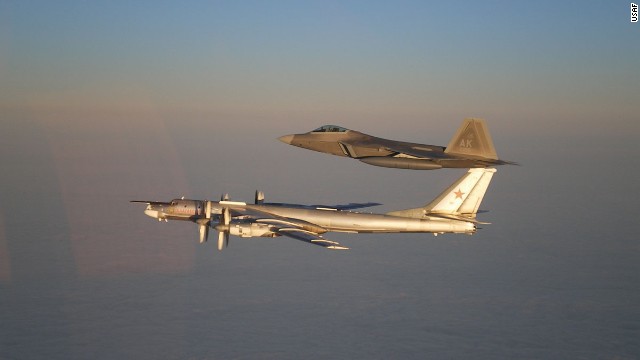 A U.S. Air Force F-22 Raptor, top, escorts a Russian Air Force Tu-95 bomber off the coast of Alaska during 2011. 