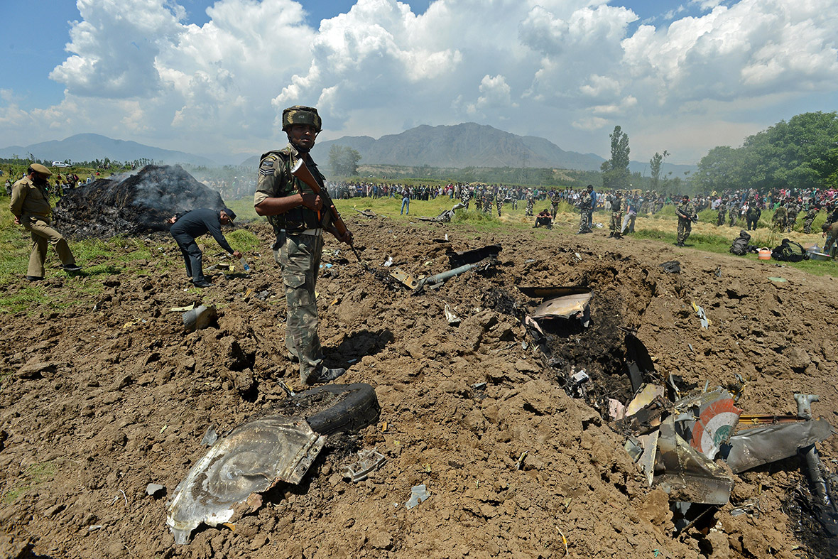 Indian army soldier stands near the wreckage of an Indian Air Force MiG-21 fighter aircraft that crashed at Marhama Bijbehara village in Anantnag district, south of Srinagar