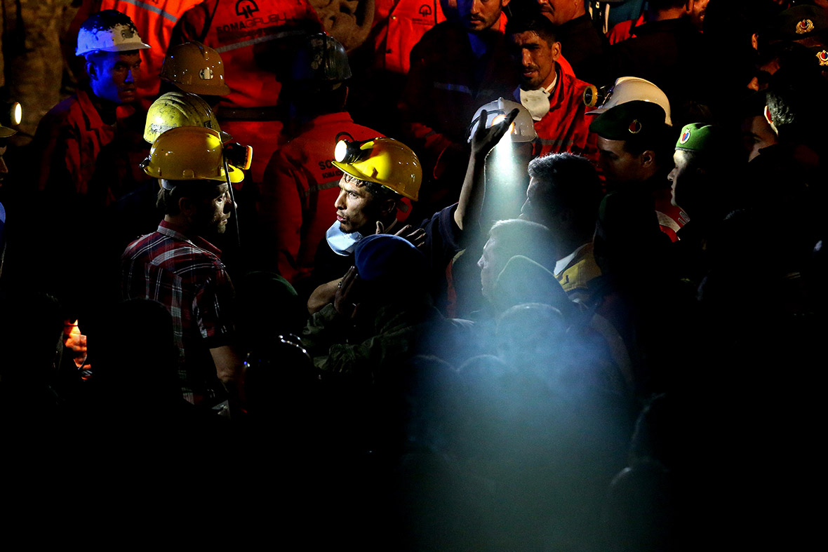 A Turkish coalminer is rescued after an explosion and fire at a pit in western Turkey