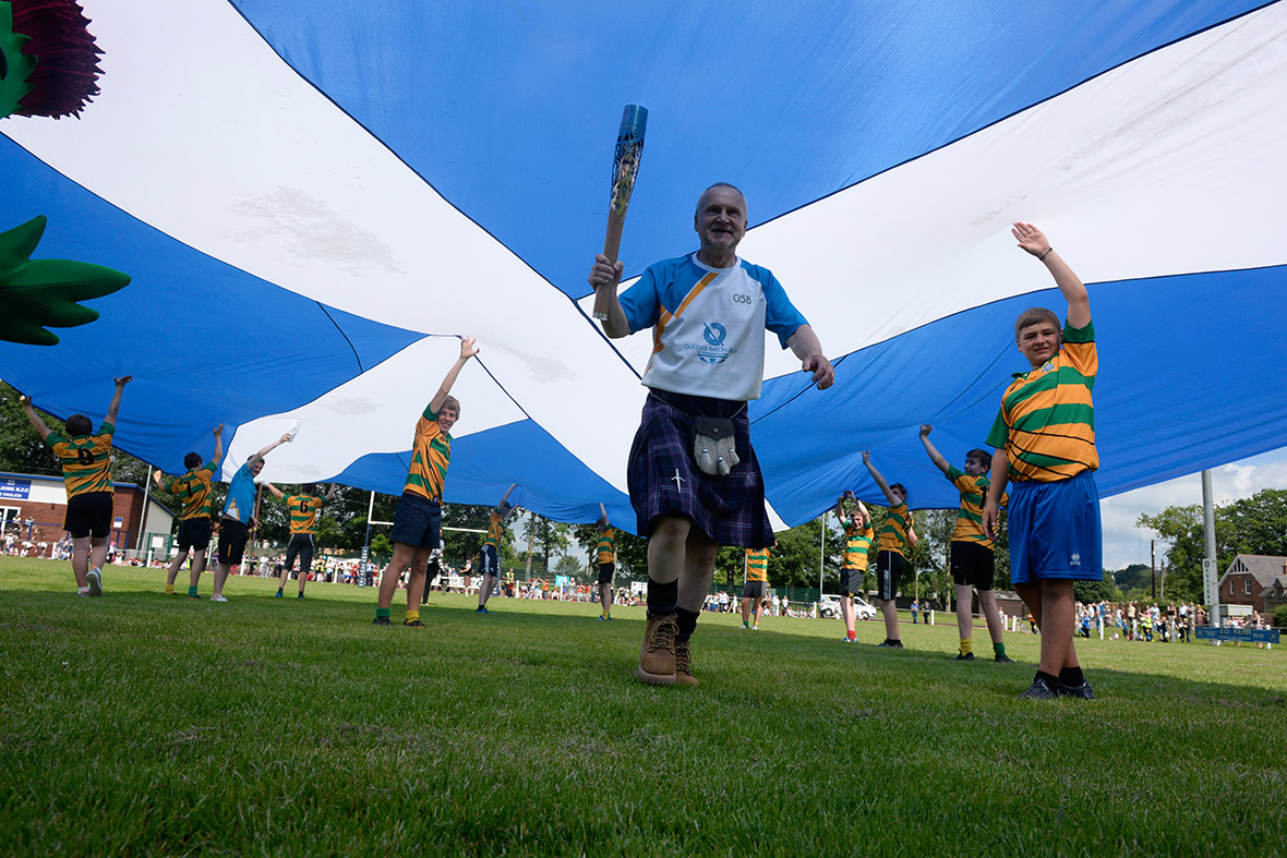 Allan McGee carries the Glasgow 2014 Queen's Baton at Selkirk Rugby Football Club in the Scottish Borders