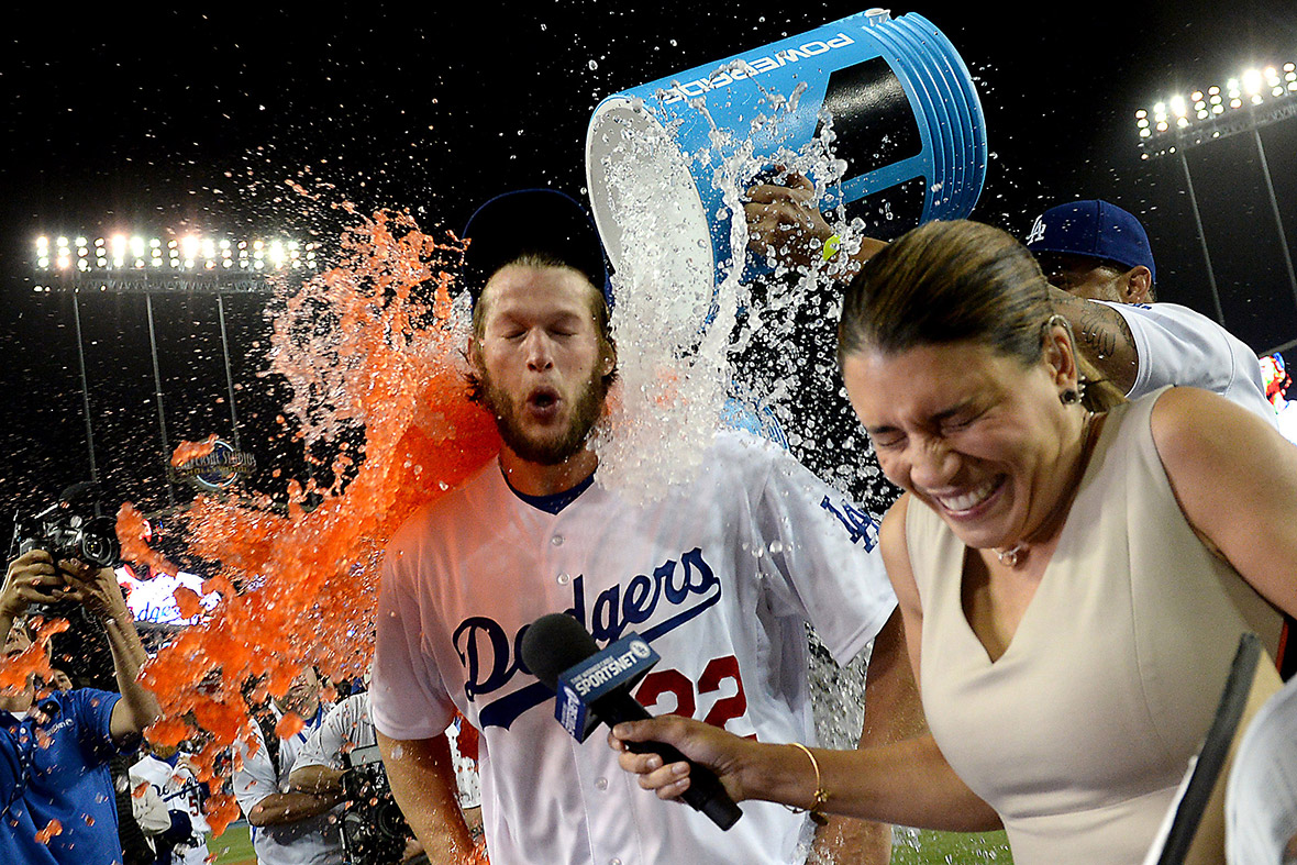 Los Angeles Dodgers' starting pitcher Clayton Kershaw is drenched with a sports drink as he gives an interview following a game against the Colorado Rockies at Dodgers Stadium