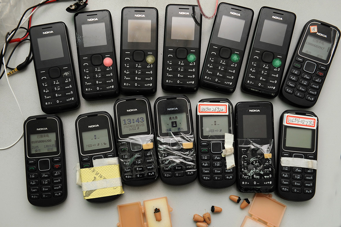 Mobile devices and receivers which can be placed in ears are displayed after being confiscated by the authorities in Chengdu, Sichuan province, China.