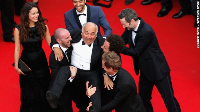 Actor Gerard Jugnot is carried by members of the cast of "Babysitting" on May 16.