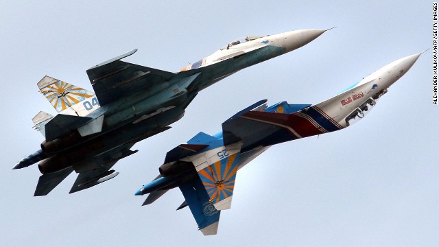 A Russian Air Force flight demonstration team perform with their Su-27 jet fighters over St. Petersburg, Russia. An Su-27 "showed its belly" to a U.S. reconnaissance jet in April.