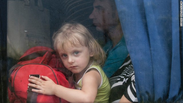 A girl looks out of a bus window as she leaves Slovyansk on Monday, June 9.