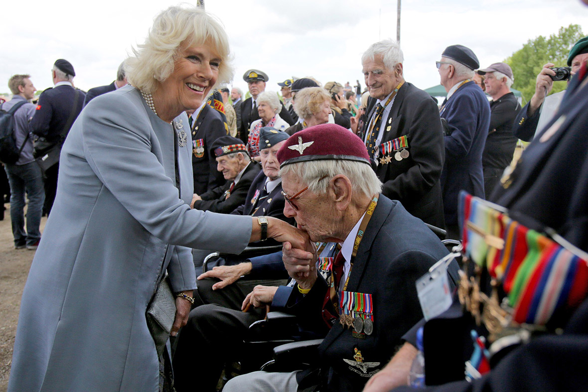 Raymond Shuck, who was a paratrooper on D-Day, kisses the hand of Camilla, Duchess of Cornwall as she meets veterans near Pegasus Bridge in Ranville, near Caen in Normandy