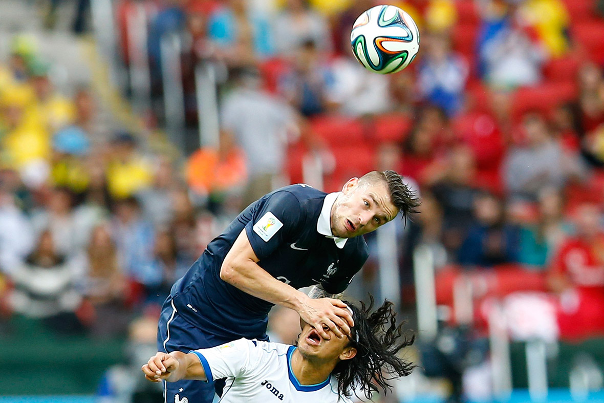 France's Mathieu Debuchy fights for the ball with Roger Espinoza of Honduras during their World Cup Group E match at the Beira-Rio stadium in Porto Alegre.
