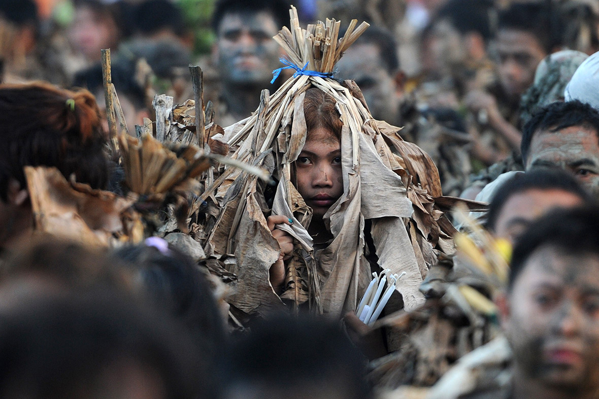 Devotees wearing banana leaves attend mass during what is known locally as the 