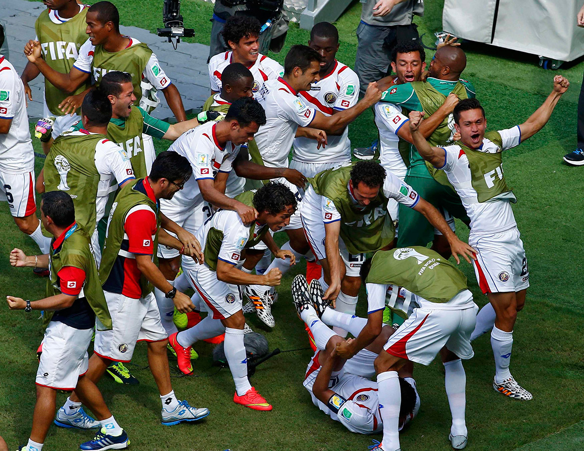 Costa Rica's players celebrate after their team-mate Bryan Ruiz (on the ground) scored the winner against Italy during their 2014 World Cup Group D match in Recife on June 20, 2014