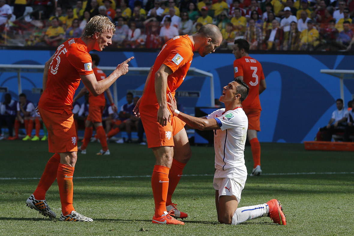 Chile's Alexis Sanchez argues with Dirk Kuyt and Ron Vlaar of the Netherlands during their 2014 World Cup Group B match in Sao Paulo