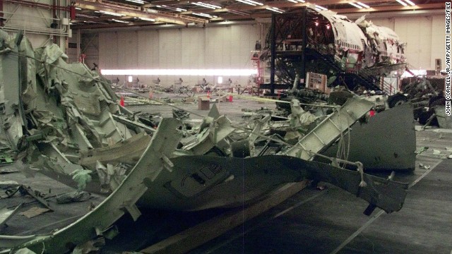 Parts of the aircraft's wing sit in the hangar on July 8, 1999, in Calverton, New York.