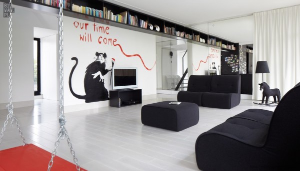 In this first home, we can see the interior immediately come to life with the Banksy-inspired mural in the living room.