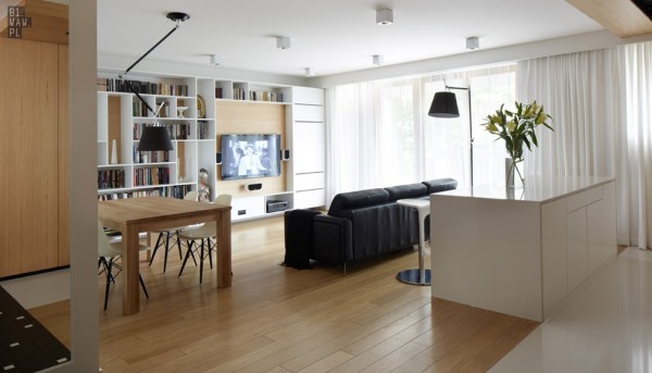 The clean lines and simple furniture leave plenty of space for a living area, small dining table, and kitchen area.