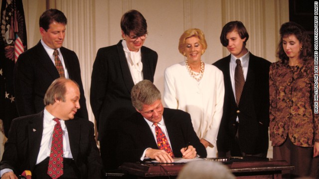 Brady is next to President Bill Clinton as Clinton signs the Brady Bill on November 30, 1993. The bill, which was fiercely fought over for years before Congress approved it, required background checks for gun purchases.