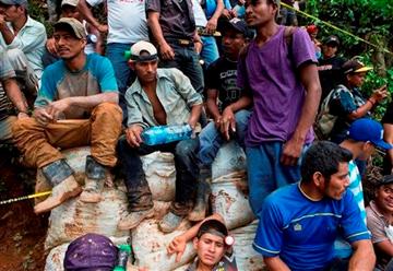 (AP Photo/Esteban Felix). Miners wait for their turn to help in the rescue operations at El Comal gold and silver mine after a landslide trapped at least 24 miners inside, in Bonanza, Nicaragua, Friday, Aug. 29, 2014.
