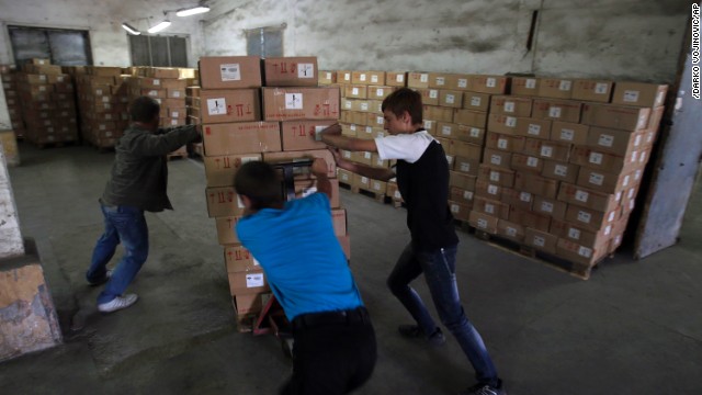 Workers unload supplies from Russia in Luhansk, Ukraine, on September 13. More than 200 Russian trucks entered Ukraine with supplies for the city, which has been cut off from electricity and water for weeks.