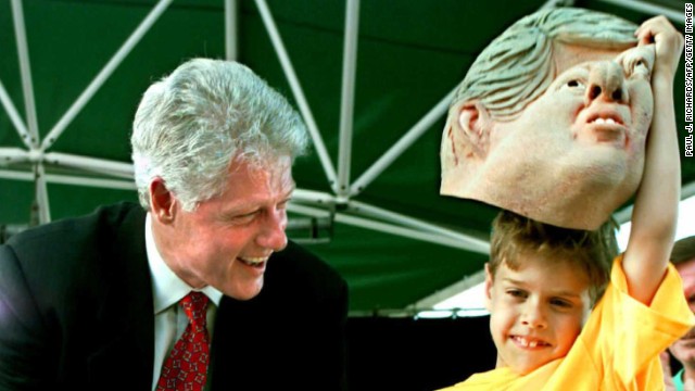 President Clinton gets a look at the person under the Clinton mask during a visit to Milwaukee, Wisconsin, on September 2, 1996.