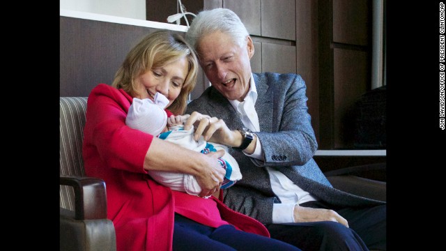 Hillary and Bill Clinton hold their granddaughter on September 27, 2014, at Lenox Hill Hospital in New York. Charlotte Clinton Mezvinsky is the first child of their daughter, Chelsea.