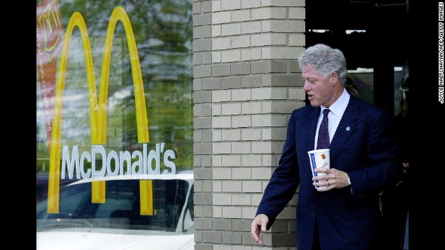 Clinton leaves McDonald's after stopping for a crispy chicken sandwich, fries and a large Diet Coke following his passing of the symbolic torch as the leader of the Democratic Party to vice president and Democratic presidential candidate Gore in Monroe, Michigan, on August 15, 2000.
