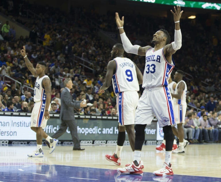 (From L) Isaiah Canaan, JaKarr Sampson and Robert Covington of the Philadelphia 76ers react after a timeout in the game against the Los Angeles Lakers, at the Wells Fargo Center in Philadelphia, Pennsylvania, on December 1, 2015