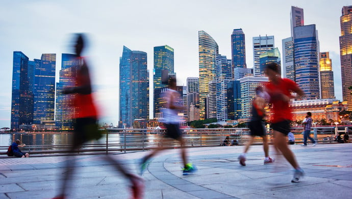 People running against the backdrop of the Central Business District in Singapore. (Image credit: Shutterstock)