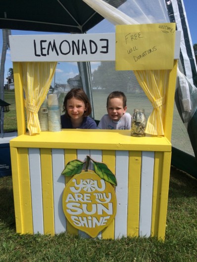 Kylah Smith, 8, and Connor Bengston, 4, give lemonade to  riders in Buckeye. (Michael Morain/The Register)