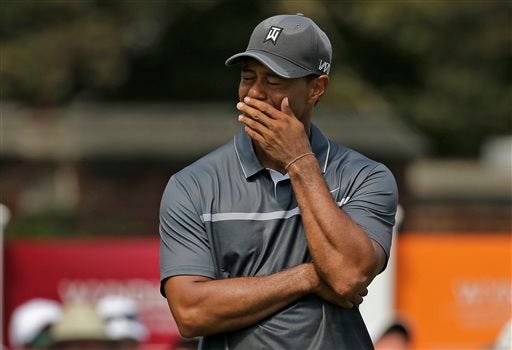 FILE - In this Aug. 21, 2015, file photo, Tiger Woods reacts after missing a putt on the ninth hole during the second round of the Wyndham Championship golf tournament in Greensboro, N.C. Tiger Woods painted a bleak picture Tuesday, Dec. 1, 2015,  on when he can return to golf or even get back to doing anything more than just walking.(AP Photo/Chuck Burton)