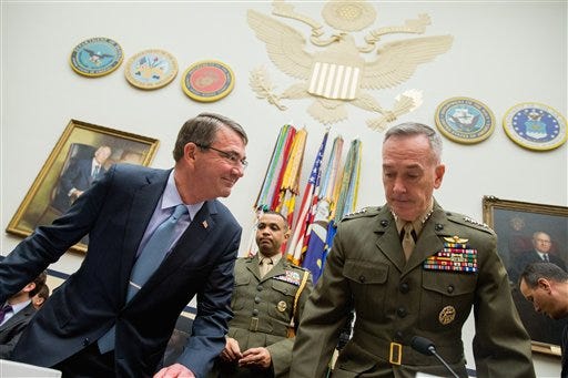 Defense Secretary Ash Carter, left, and Joint Chiefs Chairman Gen. Joseph Dunford Jr. arrive on Capitol Hill in Washington, Tuesday, Dec. 1, 2015, to testify before the House Armed Services Committee hearing on the U.S. Strategy for Syria and Iraq and its Implications for the Region. (AP Photo/Andrew Harnik)