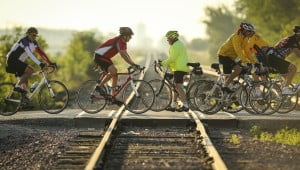 Riders cross the tracks in and out Duncombe Tuesday, July 21, 2015, during RAGBRAI XLIII.