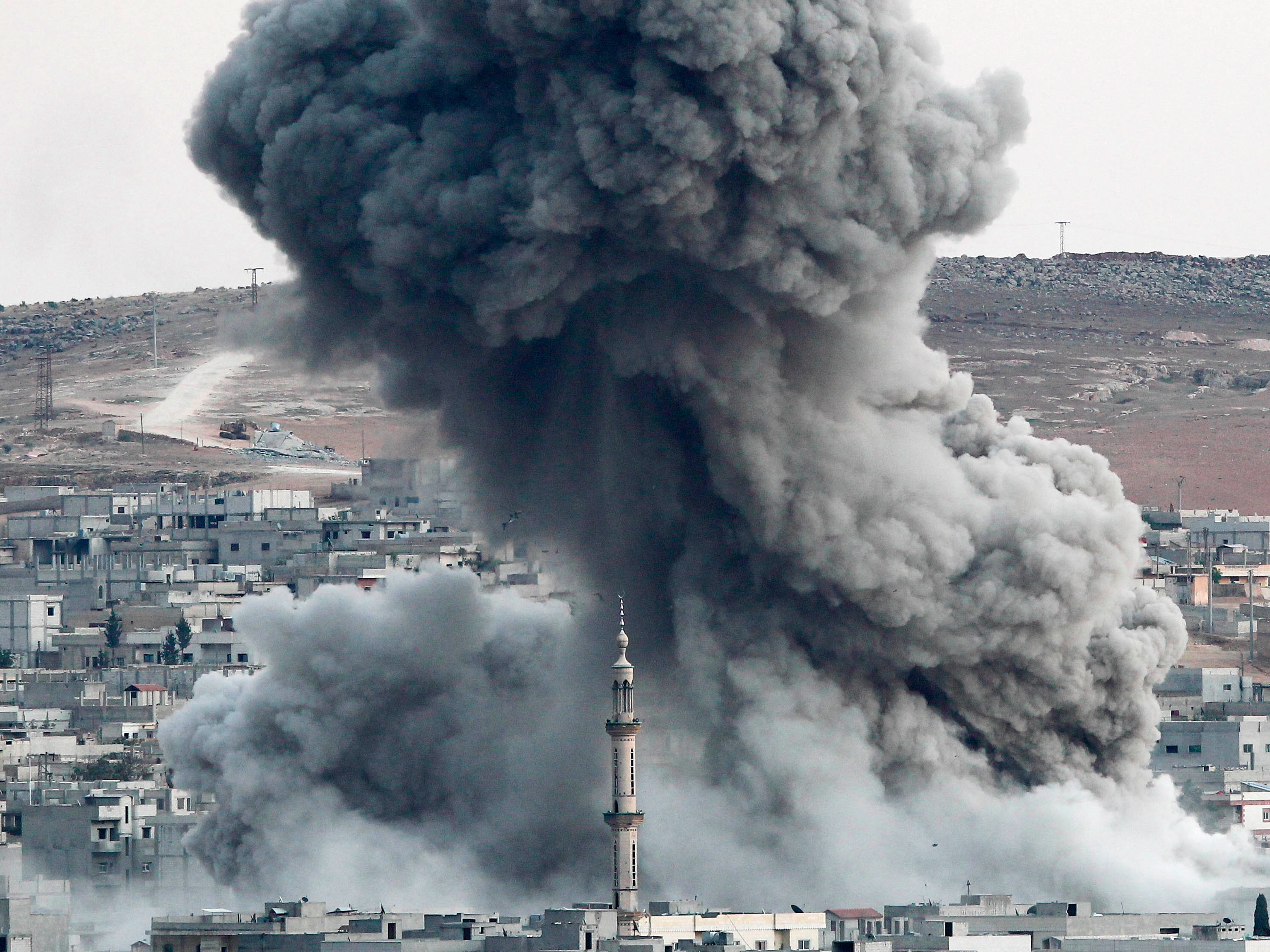 Heavy smoke rises following an airstrike by the US-led coalition aircraft in Kobani, Syria, during fighting between Syrian Kurds and the militants of Islamic State group, as seen from the outskirts of Suruc, on the Turkey-Syria border, October 18, 2014.