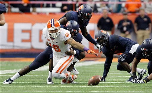 FILE - In this Nov. 14, 2015, file photo, Clemson’s Jordan Leggett, left, dives for a loose ball that he fumbled with several Syracuse players in the first quarter of an NCAA college football game in Syracuse, N.Y. Syracuse recovered the fumble. Turnovers is an area of concern the top-ranked Tigers need to shore up before facing No. 8 North Carolina for the ACC championship Saturday night. (AP Photo/Nick Lisi, File)