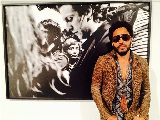 In this image taken from video, Musician Lenny Kravitz stands in front of one of his photos from his exhibit 