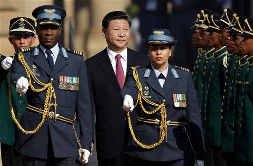 Chinese President Xi Jinping, reviewsan honor guard during a welcome ceremony at Union Building Pretoria, South Africa, Wednesday, Dec. 2, 2015.  (AP Photo/Themba Hadebe)