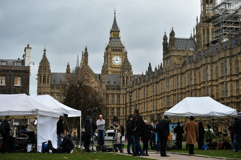 News crews gather outside the Houses of Parliament in London on December 2, 2015, where members of parliament were debating a motion to join air strikes on Islamic State (IS) group targets in Syria